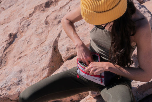 Girl in hat rummaging through her crossbody