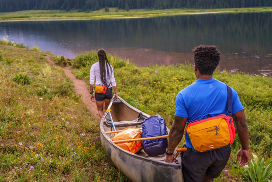friends carrying a canoe