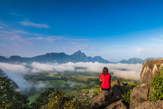 Young girl travels on high mountain in Vang-Vieng