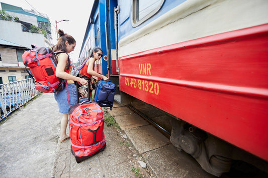 girls getting on a train with gear