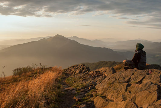 girl meditating on cliff