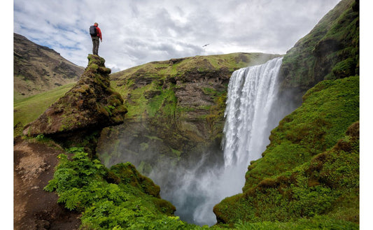 Man looking at waterfall