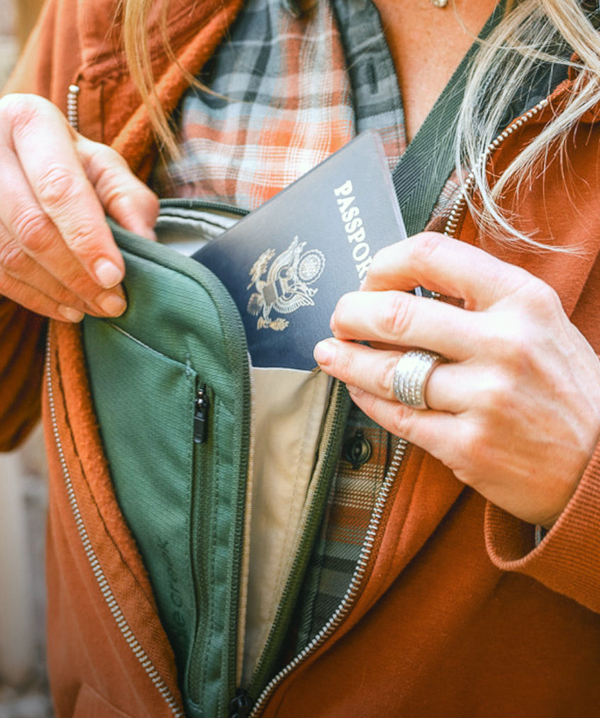 A woman stashes her passport in an Eagle Creek neck wallet