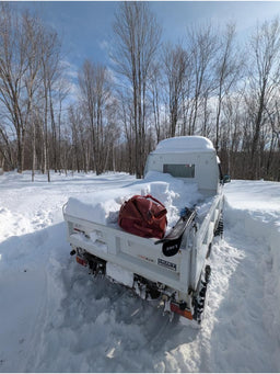 An Eagle Creek duffel bag in the back of a snow cat